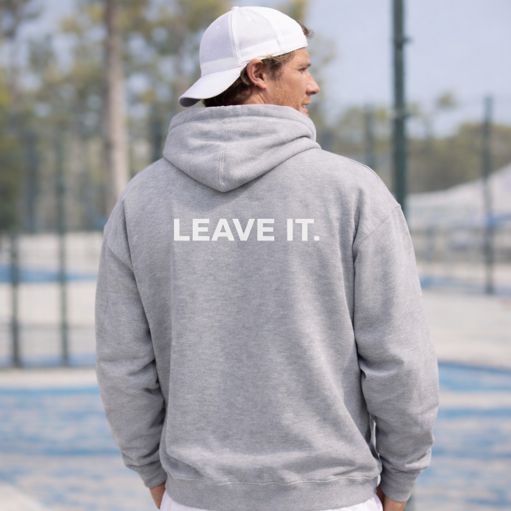 Person wearing a gray hoodie with 'LEAVE IT.' text on the back, standing outdoors.