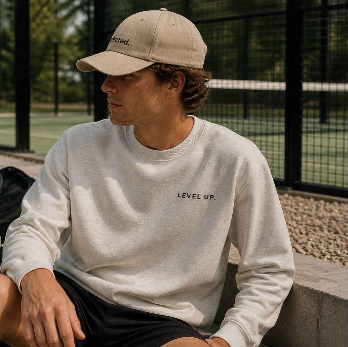 man outside padel court with slogan level up on 