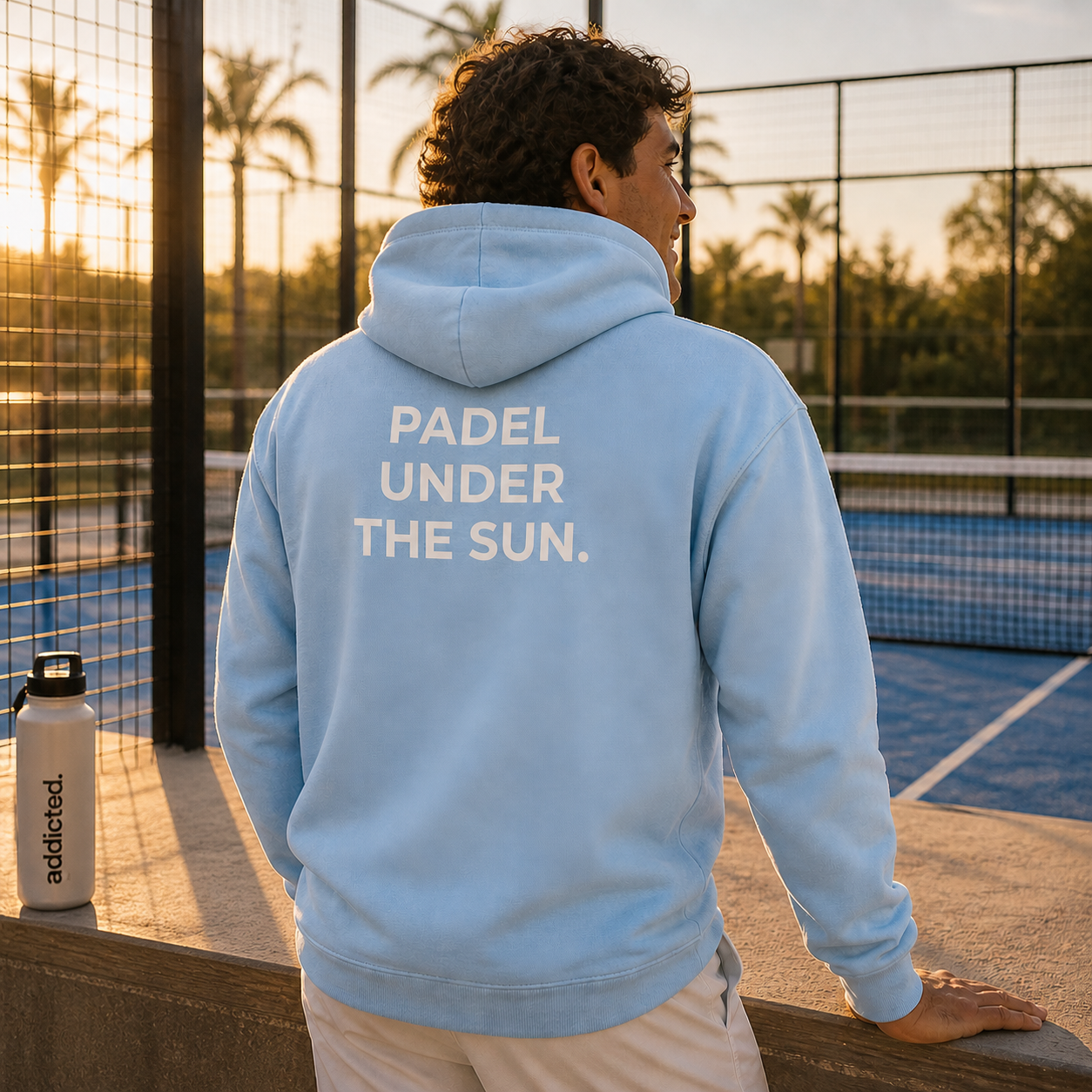 man on padel court with padel under the sun hoodie on