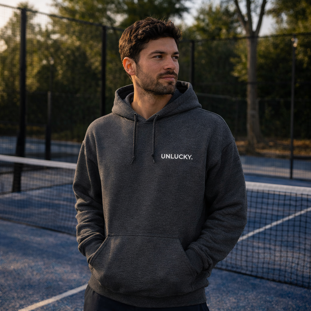 man on padel court wearing unlucky hoodie